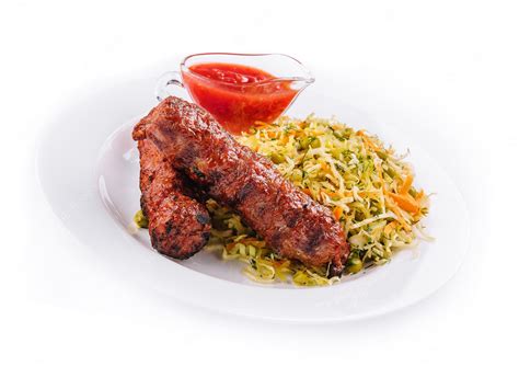 Premium Photo | Moldavian traditional mititei mici meat sticks with cabbage and a sauce