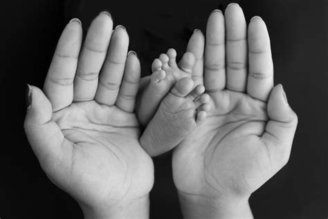 Premium Photo | Black and white shade beautiful shape hands of mother hold tiny newborn baby ...