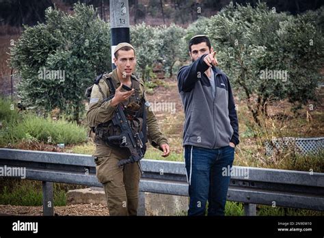 A Golani soldier and a citizen standing and talking in the city of ...