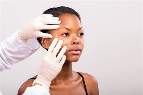 Dermatologist Checking Young African American Woman Face Skin Stock Photo - Download Image Now ...