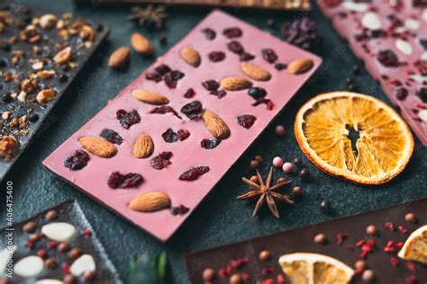 Handmade chocolate bars with a variety of dried fruit and nut toppings. Stock Photo | Adobe Stock