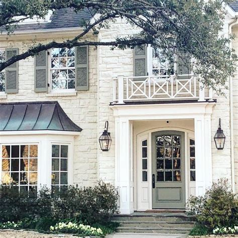 a large white house with a clock on the front door