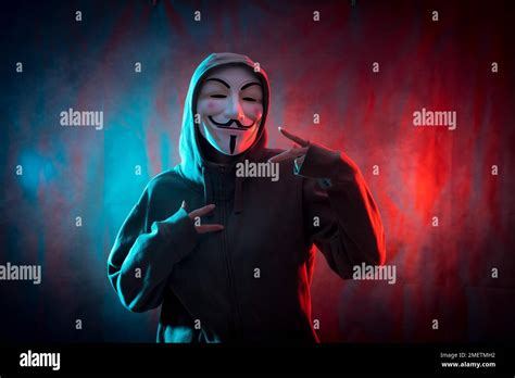 Hacker with anonymous mask making the victory symbol, red and blue ...