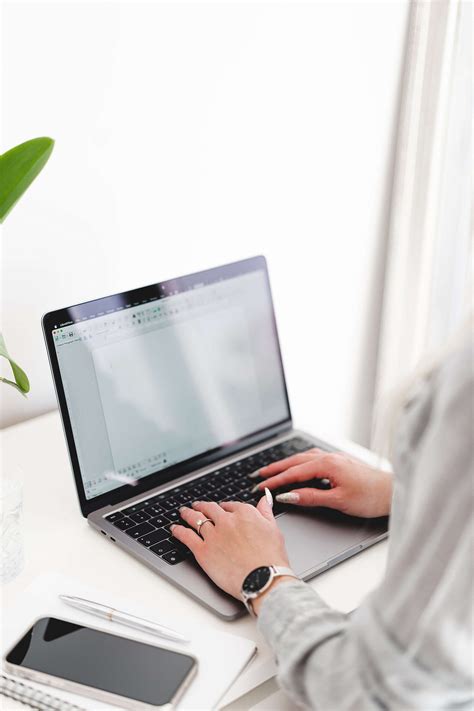 Woman Writing on Her Laptop in a Bright White Office Free Stock Photo | picjumbo