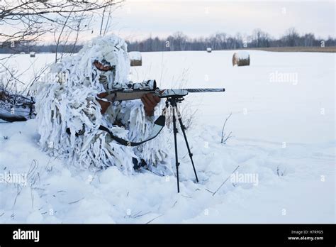 Varmint Hunter In Ghillie Snow Suit With Rifle On Bipod in winter Stock Photo - Alamy