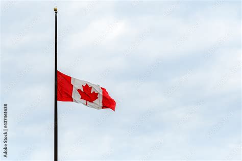 A Canadian flag at half mast, lowered in remembrance of the indigenous ...