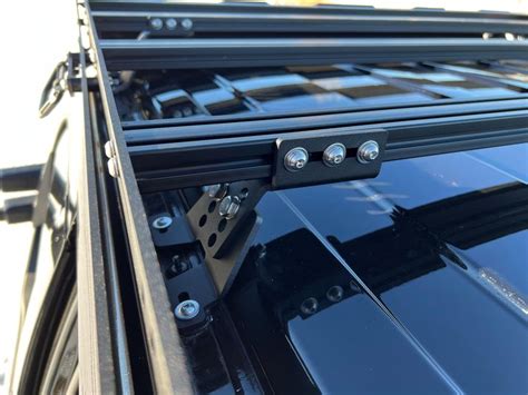 the back end of a black truck with metal latches