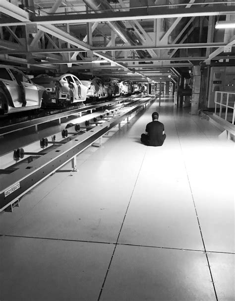 Elon Musk sitting on the Fremont production floor during "production ...