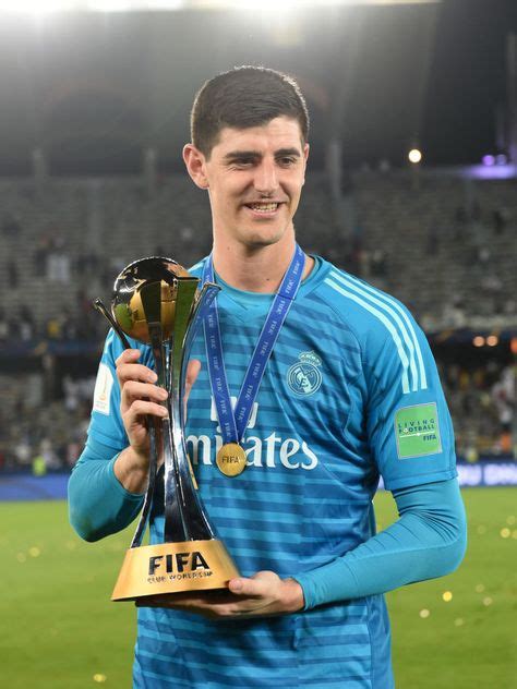 Thibaut Courtois of Real Madrid celebrates with the trophy after the...