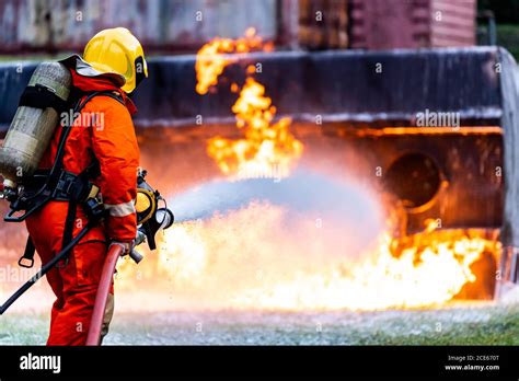 Firefighters spraying down fire flame from oil tanker truck accident ...