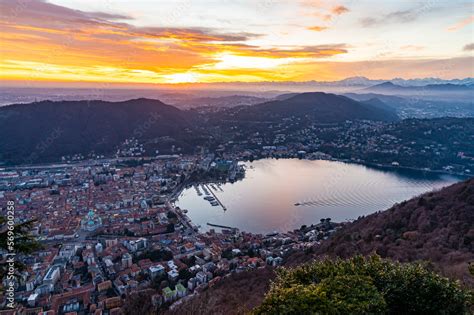 The city of Como, the lakefront and the lake, photographed from Brunate, at dusk, and all the ...