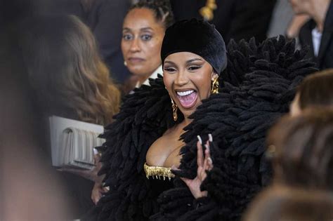 Cardi B throws a microphone at a fan who threw a drink at her : NPR