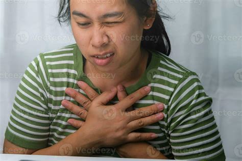 Woman holding her chest with a heart attack. Women have chest pain caused by heart disease ...