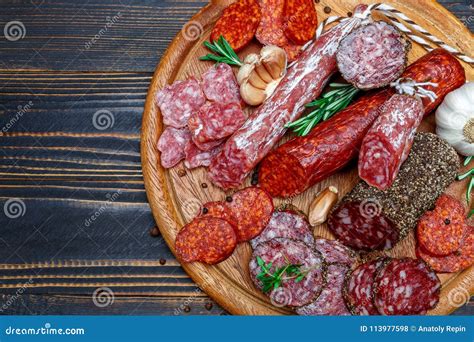 Various Types of Dried Organic Salami Sausage on Wooden Cutting Board Stock Photo - Image of ...