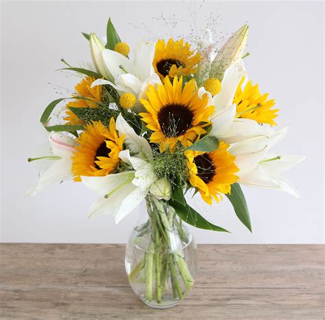 Sunflower & Lillies Bouquet: • 6 Sunflower • 3 White oriental lily • 3 Panicum • 3 Craspedia ...