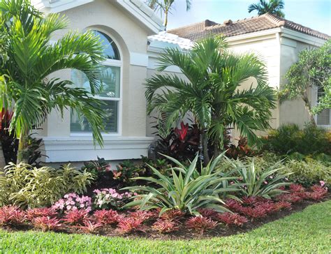Palms and tropical color form this landscape in the Ballenisles community in Palm Beach Gardens ...