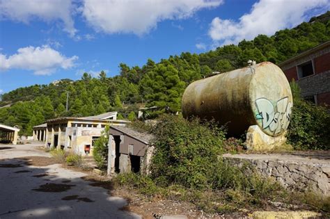 Premium Photo | A large tank with graffiti on it sits in front of a ...