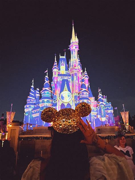 Girl wearing Mickey ears 1000 50th anniversary ears gold with jewels in ...