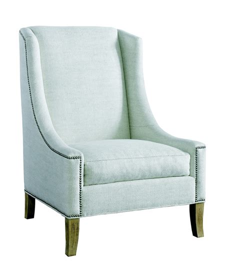 an upholstered white chair with wood legs and nail polishing on the arm