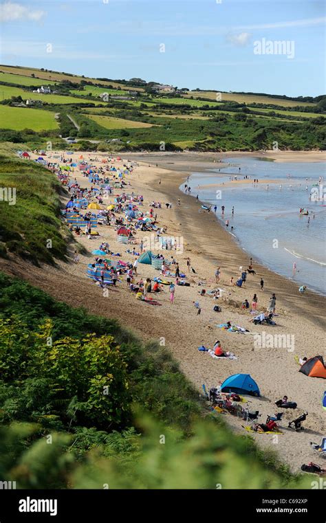 Holidaymakers enjoying a sunny day on Moelfre beach, Anglesey, North Wales Stock Photo - Alamy