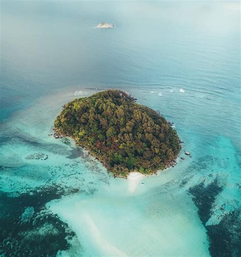 Soaring above Moyenne Island, a tiny little oasis with only 100’s of ...