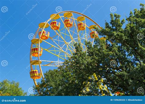 Ferris Wheel Against Blue Sky Background on Sea Promenade. Attractions and Entertainment during ...