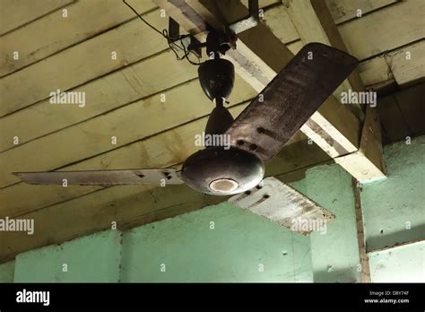 Old ceiling fan mounted on rafters Stock Photo - Alamy