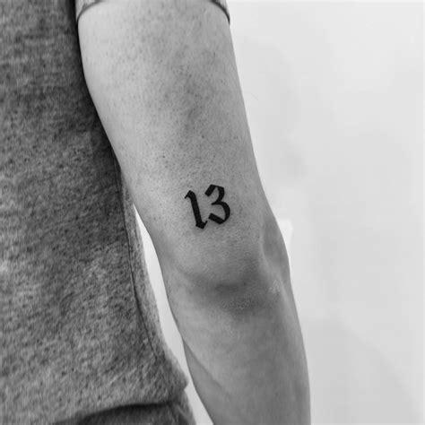 Tattoo of the number "13" done on the tricep.