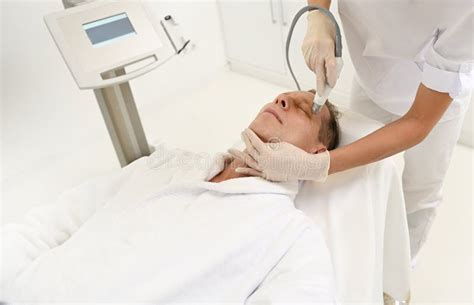 Aesthetician Performs Facelift Procedure for Mature Man Using Modern Ultrasonic Equipment in SPA ...