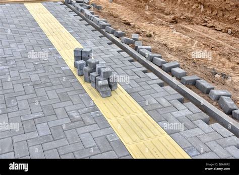 Laying paving slabs at construction site. Process of installing paving ...