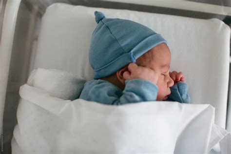 "Newborn Baby Boy Sleeping In A Hospital Room." by Stocksy Contributor "BONNINSTUDIO " - Stocksy