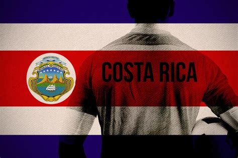 Premium Photo | Costa rica football player holding ball against costa rica national flag