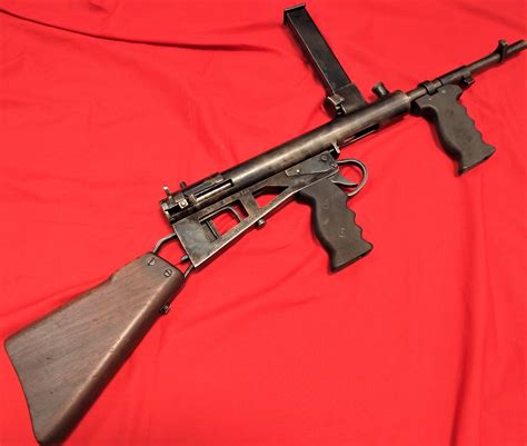 Replica WW2 Australian Owen Sub Machine Gun. Wooden butt stock attached to detailed metal body, w