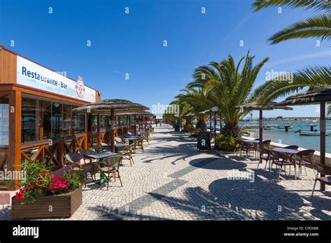 Seafront restaurants by the harbour in the resort of Alvor, near ...