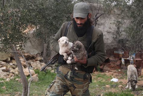 Photos: The Free Syrian Army Fighter Who Takes Care of Puppies - Newsweek