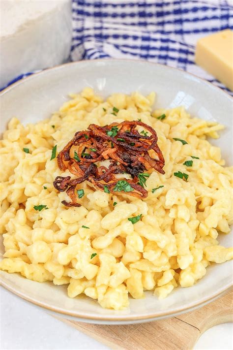 Want to make delicious and cheesy Käsespätzle? This classic German cheese spaetzle recipe is ...