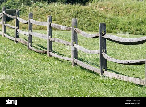 old wood fence on green grass background view Stock Photo - Alamy