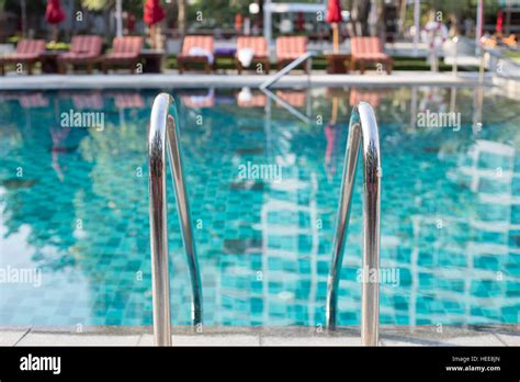 Outdoor swimming pool with shiny stainless steel stair Stock Photo - Alamy