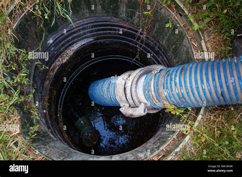 Emptying household septic tank. Cleaning sludge from septic system Stock Photo - Alamy