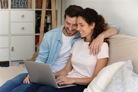 Happy Wife and Husband Hugging, Using Laptop Together at Home Stock ...