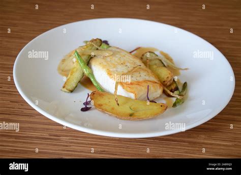 white fish plate potatoes fine dining restaurant dish Stock Photo - Alamy