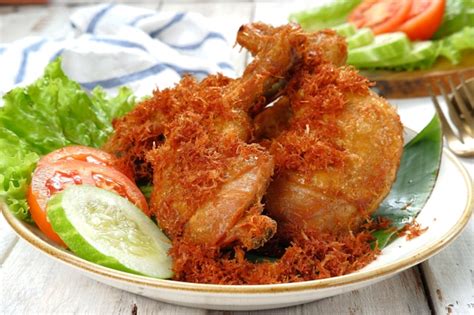 Premium Photo | Ayam goreng serundeng, fried chicken sprinkled with grated coconut with curry ...