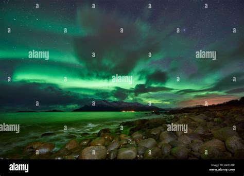 Aurora Borealis or northern lights over winter landscape in fjord of ...