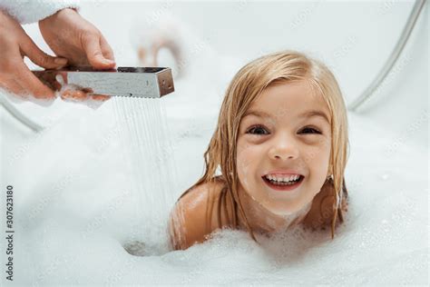 cute and naked kid taking bath near mother in bathroom Stock Photo ...