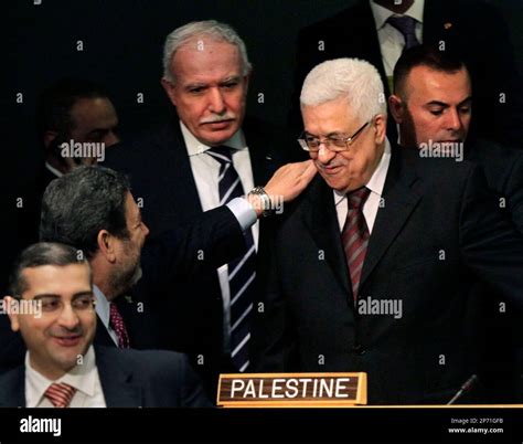 Palestinian President Mahmoud Abbas, center, is greeted before the start of speeches at the 66th ...