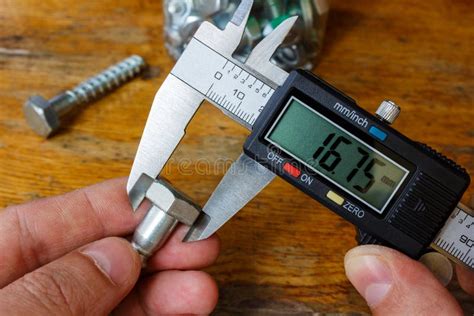 Measurement of the Bolt Head with an Electronic Caliper Stock Image - Image of machine ...