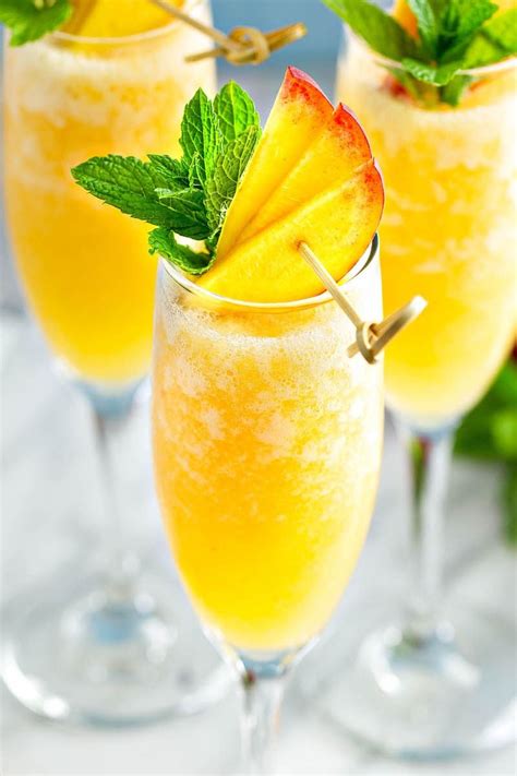 Peach Bellini in a glass with fresh peaches and mint on top. | Peach ...