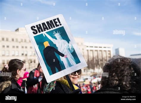 An anti Trump protest sign depicting President Trump grabbing the ...