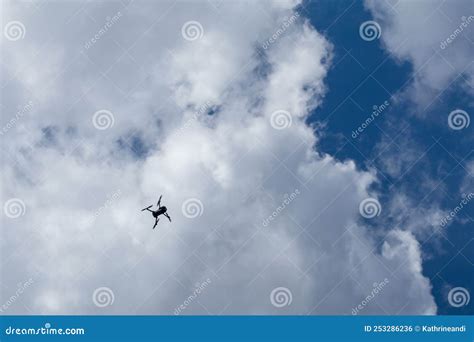 Drone Silhouette in White High Clouds on Blue Sky Stock Photo - Image of drone, outdoors: 253286236