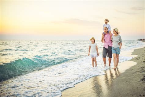 Happy family walking along a sandy beach